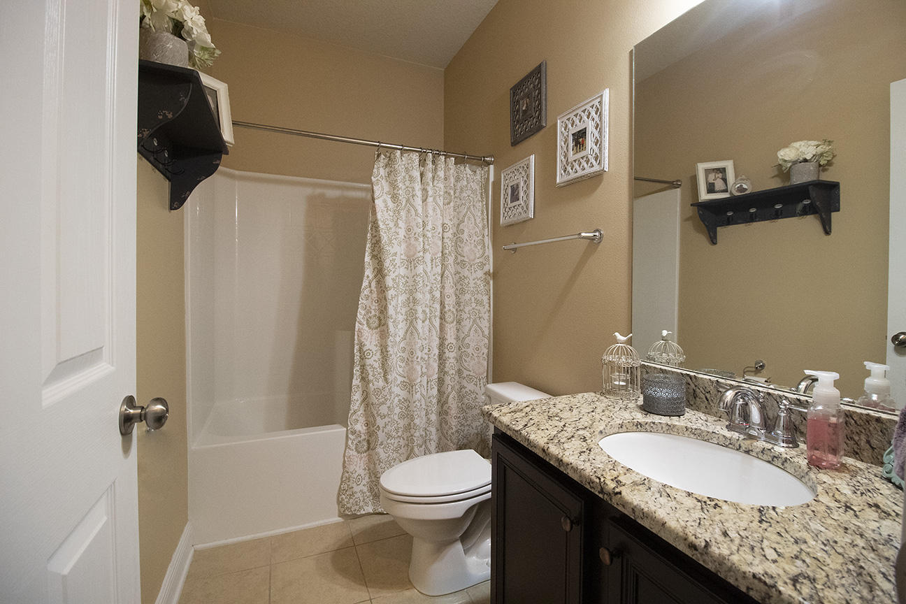 206 Mango Lane Freeport, FL 32439 - Photo 24 of 45 a bathroom with a granite countertop sink toilet and shower