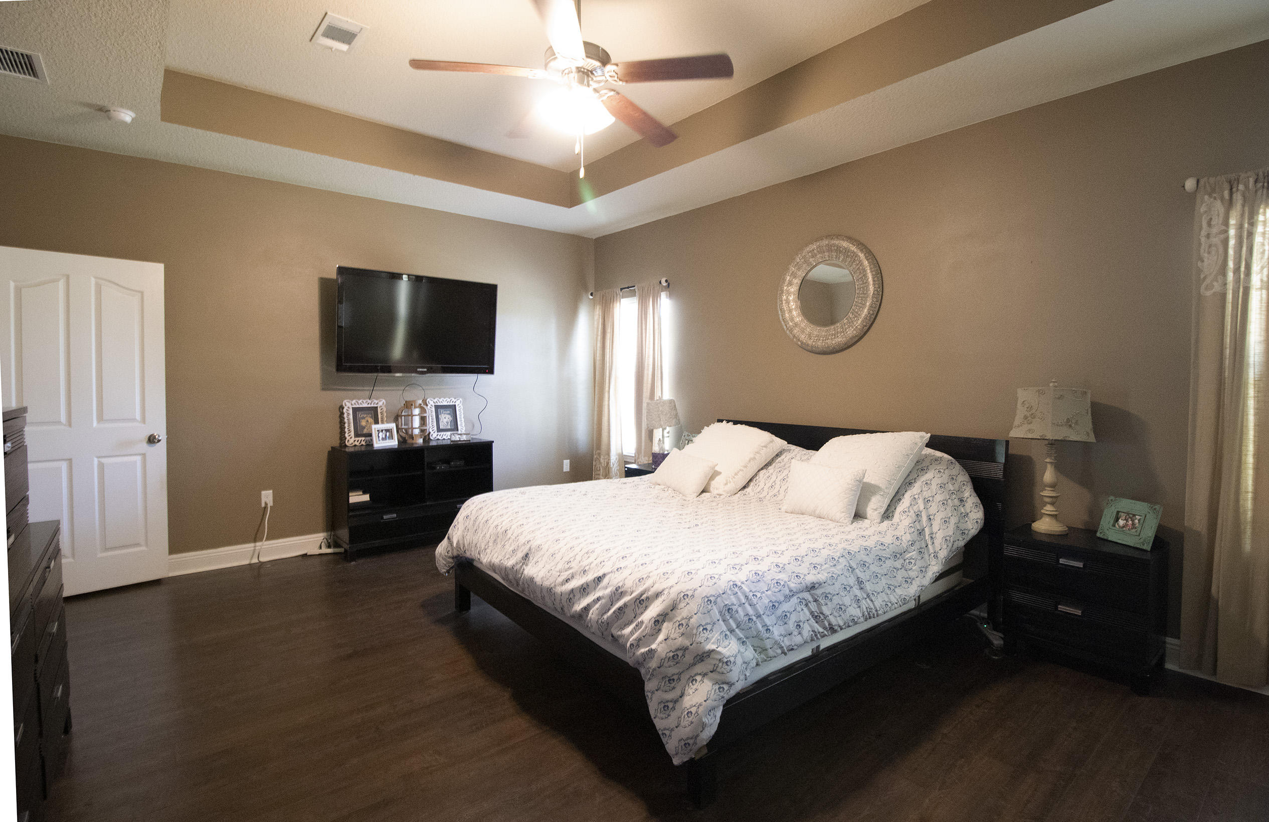 206 Mango Lane Freeport, FL 32439 - Photo 27 of 45 a bedroom with a bed and a flat tv screen on dresser