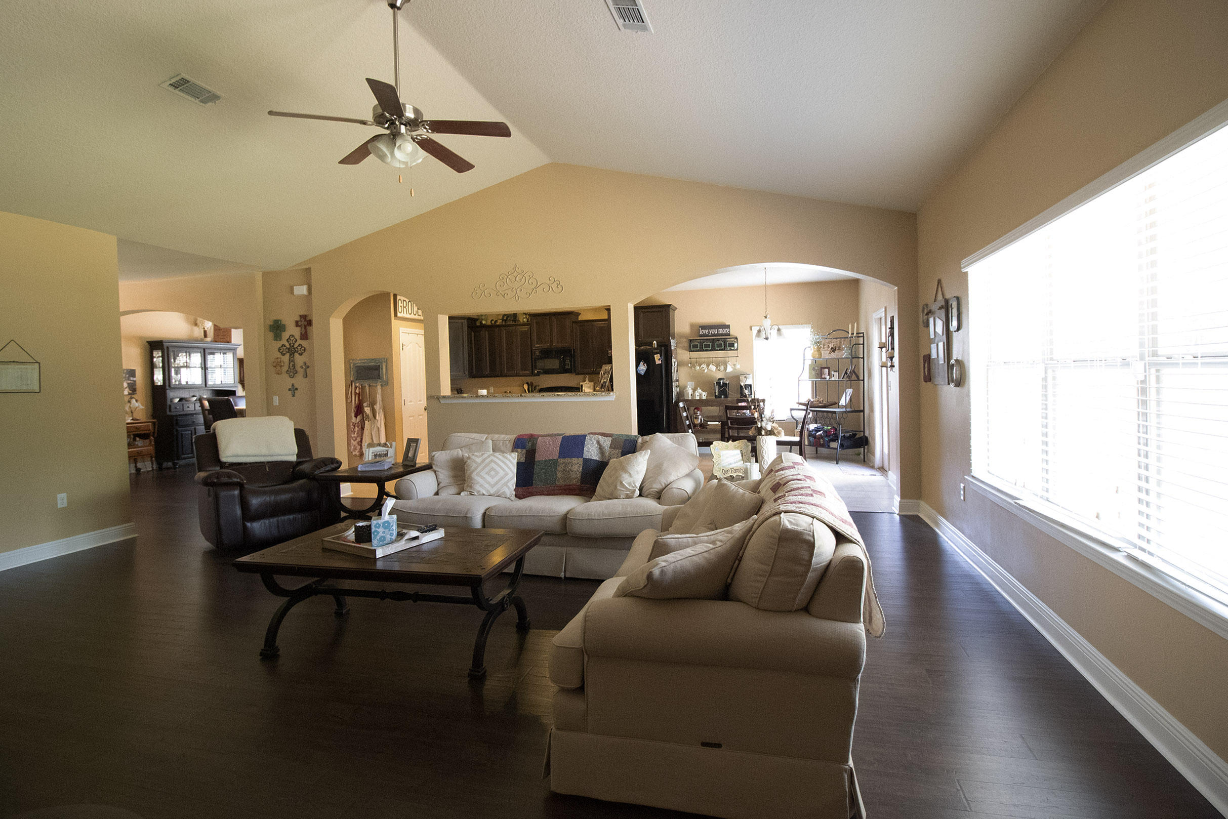 206 Mango Lane Freeport, FL 32439 - Photo 32 of 45 a living room with furniture a ceiling fan and a large window