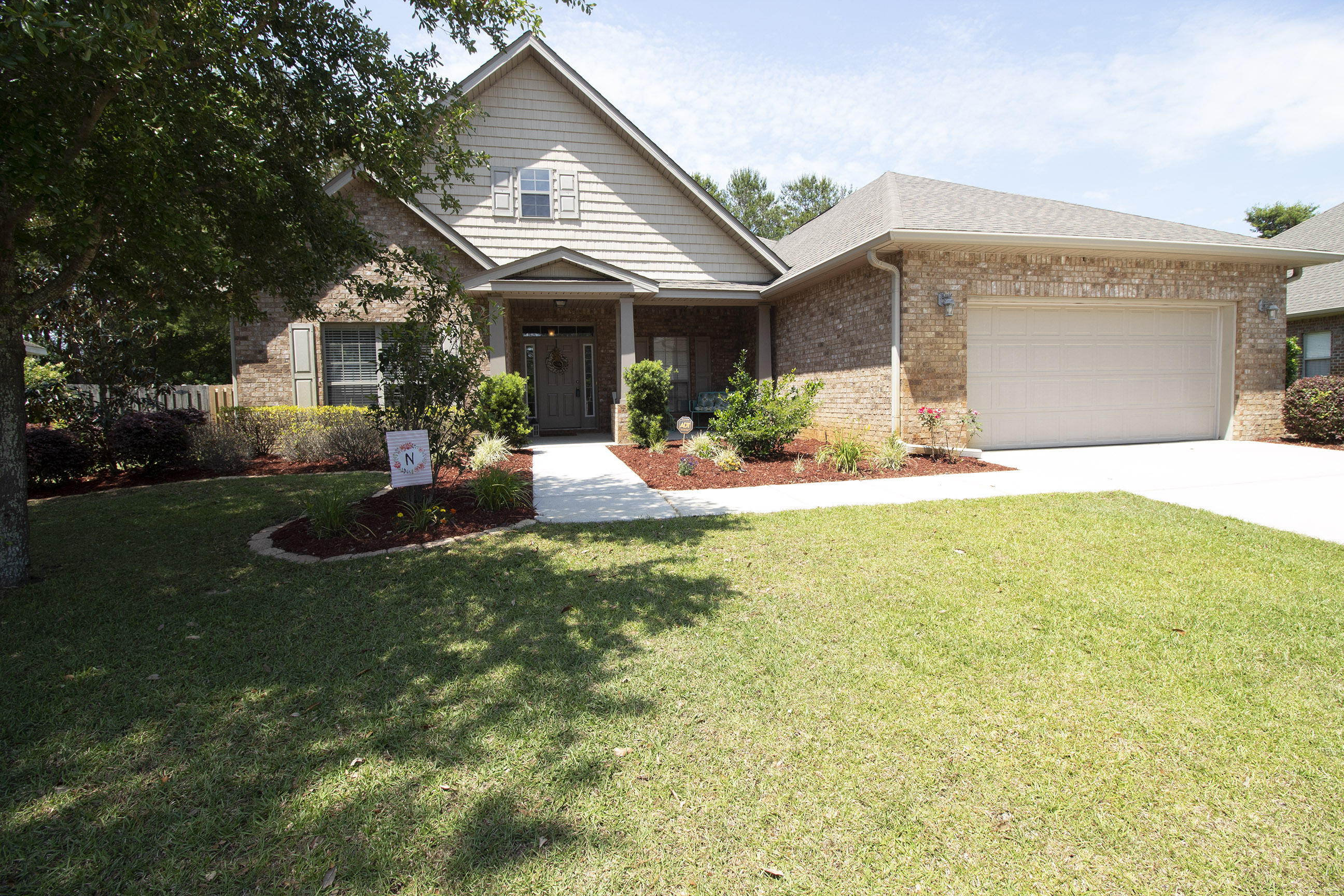 206 Mango Lane Freeport, FL 32439 - Photo 4 of 45 a front view of a house with a patio