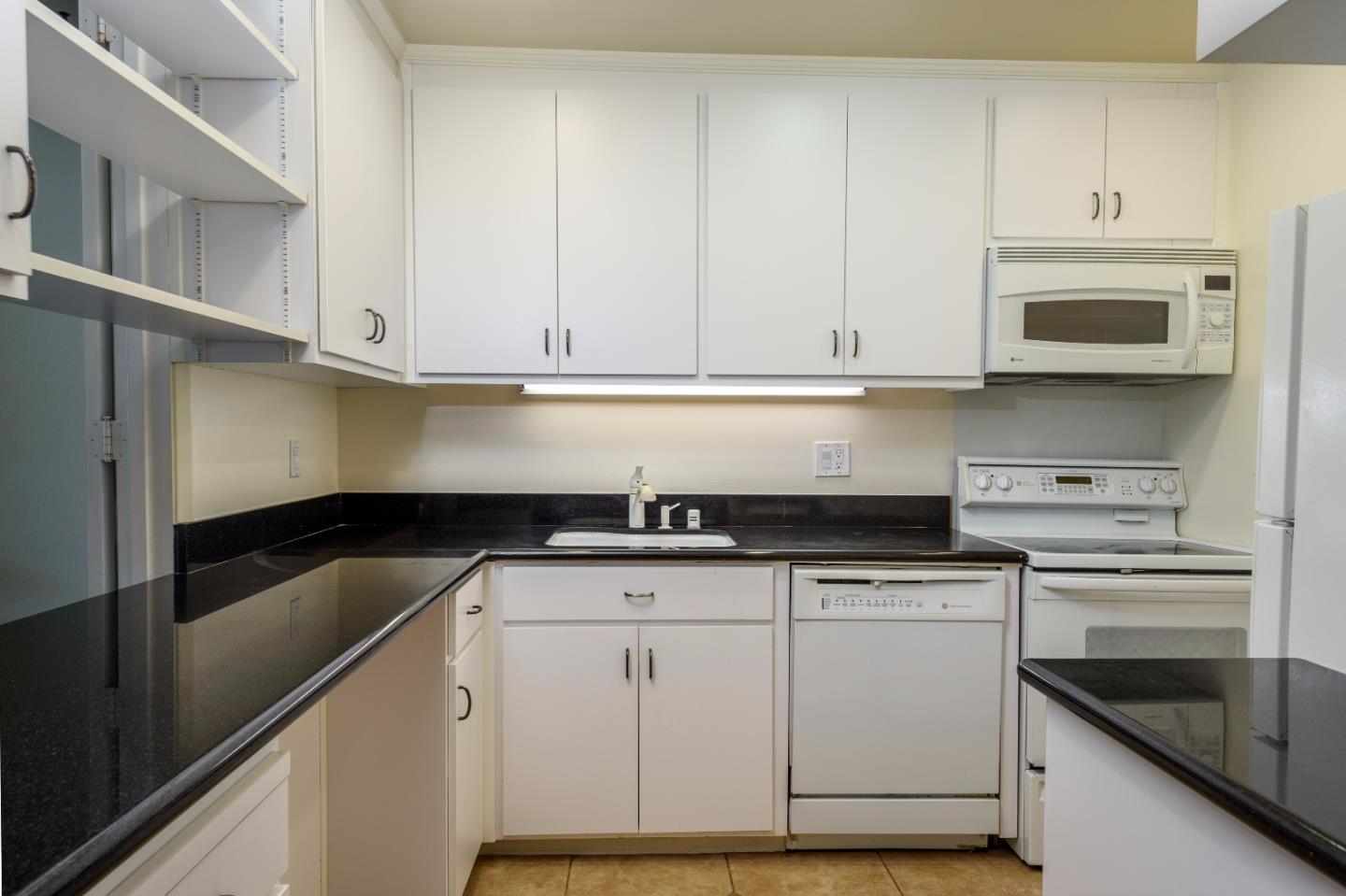200 Elm Street, Unit 107 San Mateo, CA 94401 - Photo 6 of 11 a kitchen with granite countertop a sink and cabinets