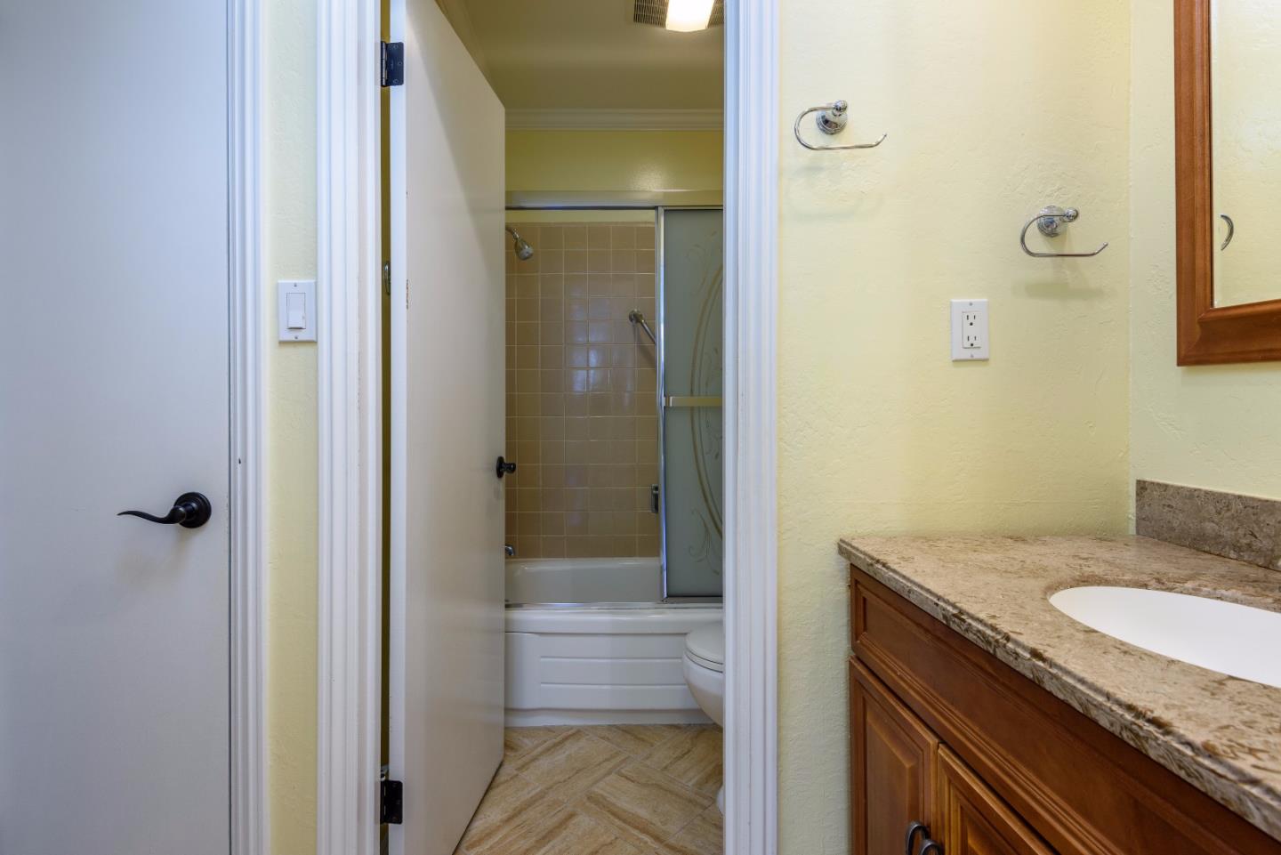 200 Elm Street, Unit 107 San Mateo, CA 94401 - Photo 10 of 11 a bathroom with a granite countertop sink and a mirror