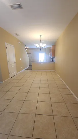 a view of wooden floor and windows in a room