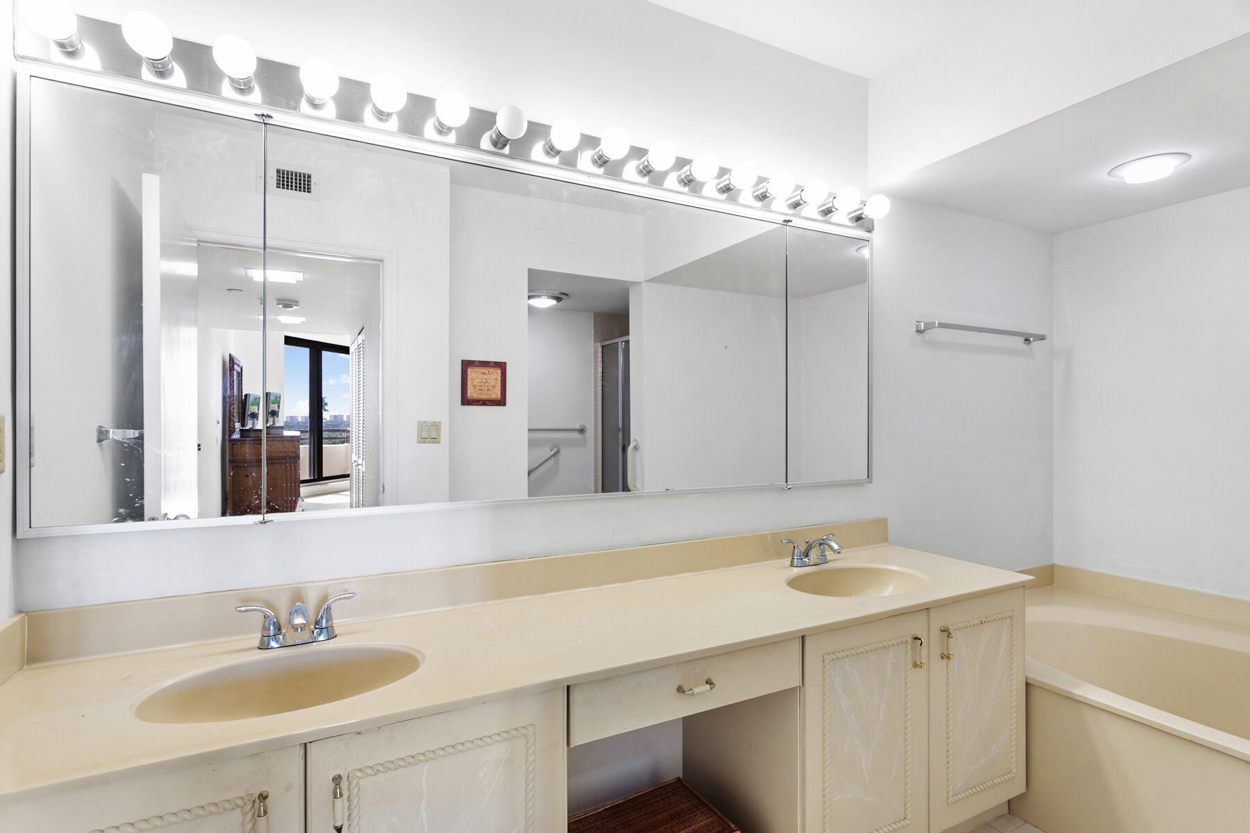3322 Casseekey Island Road, Unit 504 Jupiter, FL 33477 - Photo 18 of 46 a bathroom with a sink double vanity and a mirror