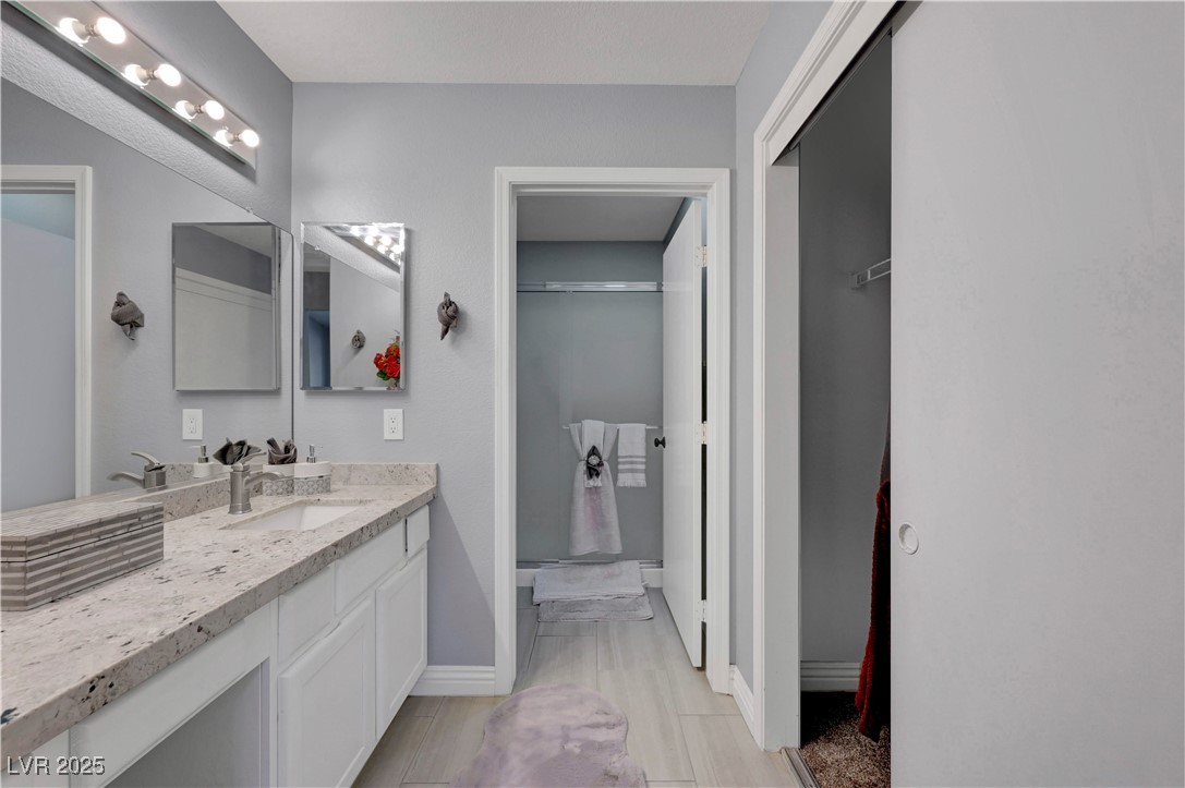Undisclosed Address Las Vegas, NV 89134 - Photo 15 of 39 Bathroom with a shower stall, vanity, and light wood-style floors
