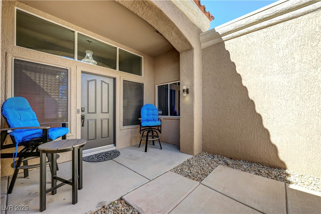Undisclosed Address Las Vegas, NV 89134 - Photo 30 of 39 View of exterior entry featuring stucco siding and a patio area