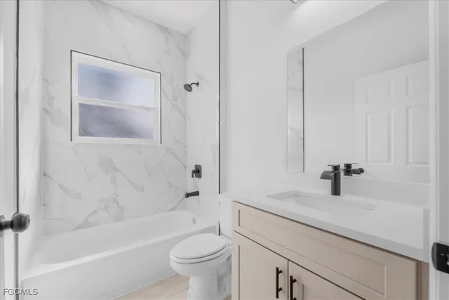 a bathroom with a sink a toilet and a bathtub