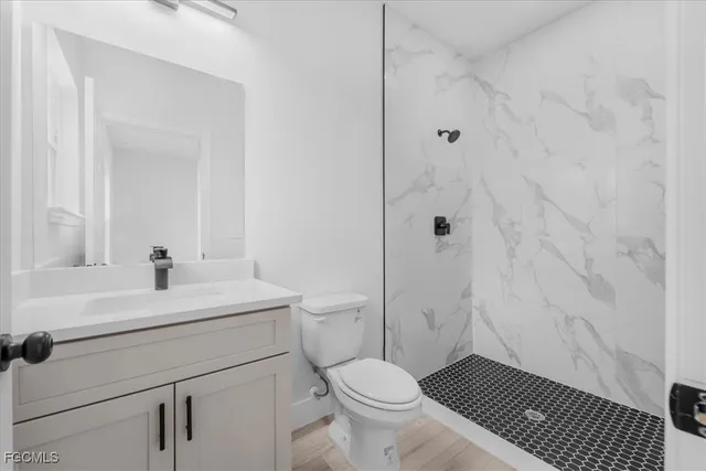 a bathroom with a sink toilet a shower and a mirror