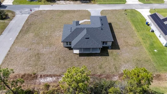 an aerial view of a house with a yard