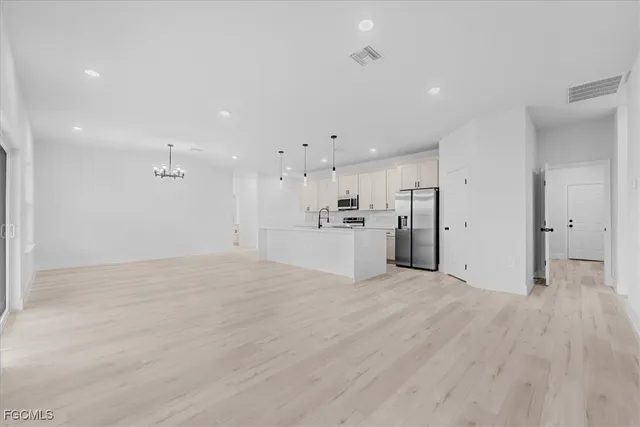 a view of a kitchen with a sink and a refrigerator