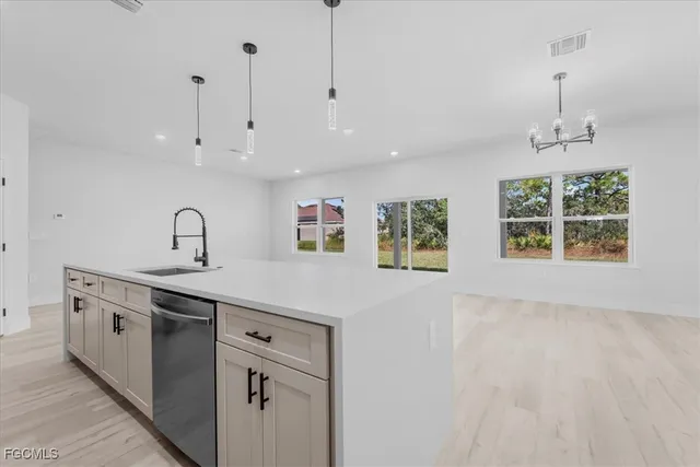 a kitchen with a sink stainless steel appliances and cabinets