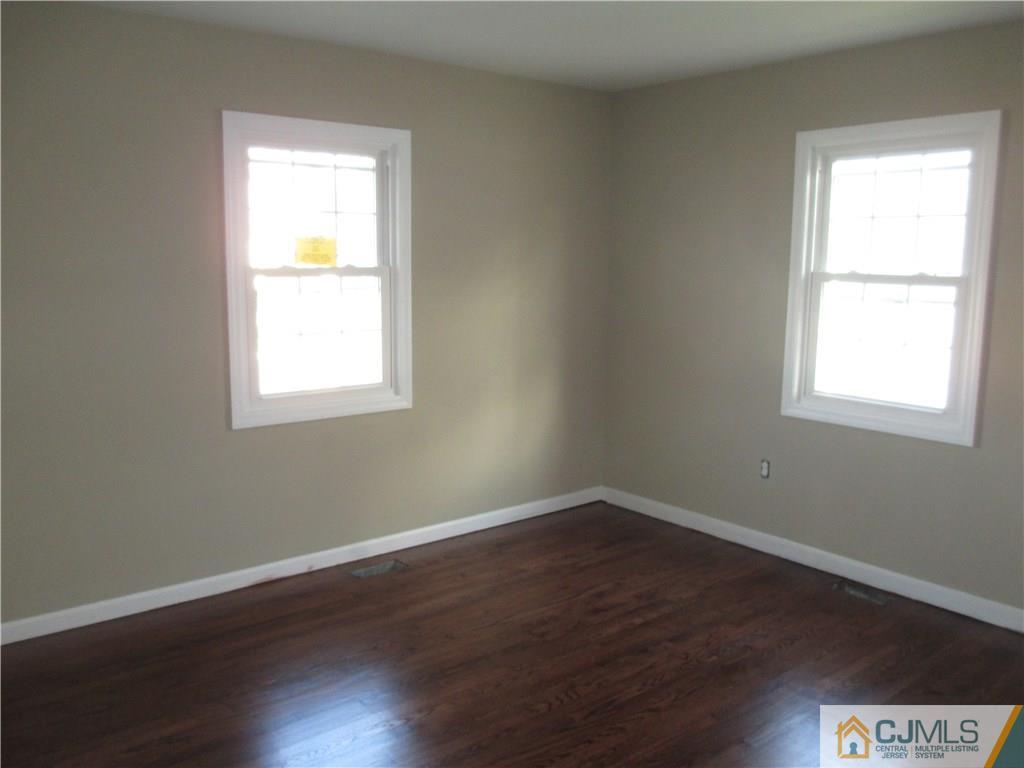77 Middle Hill Road Colonia, NJ 07067 - Photo 17 of 21 an empty room with a window and wooden floor