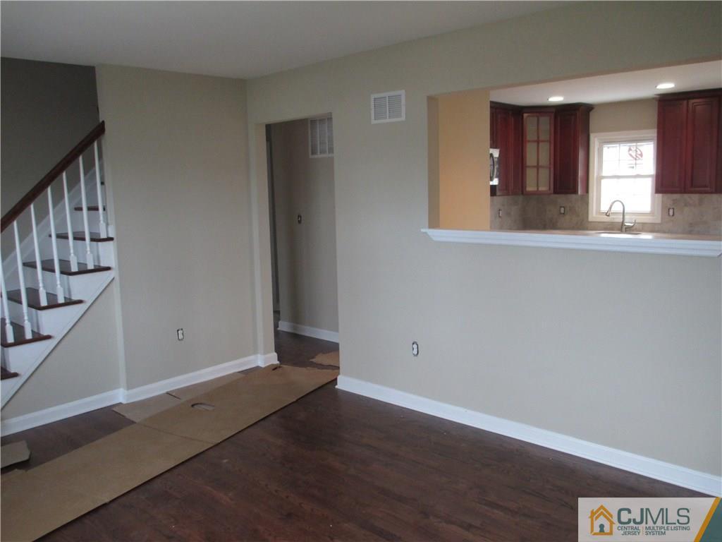 77 Middle Hill Road Colonia, NJ 07067 - Photo 5 of 21 a view of an empty room with wooden floor and a window