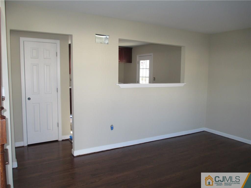 77 Middle Hill Road Colonia, NJ 07067 - Photo 6 of 21 a view of an empty room with wooden floor and a window