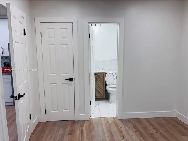 a view of a livingroom with wooden floor and closet