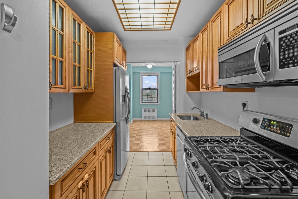 2400 Johnson Avenue, Unit 2F Bronx, NY 10463 - Photo 10 of 25 a kitchen with stainless steel appliances granite countertop a stove and a sink