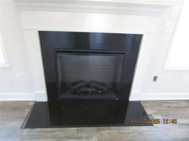 a living room with a fireplace and a rug