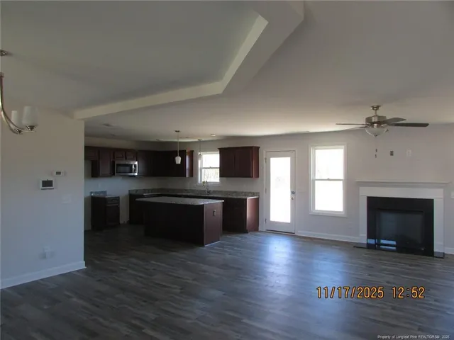a kitchen with a refrigerator and a stove top oven