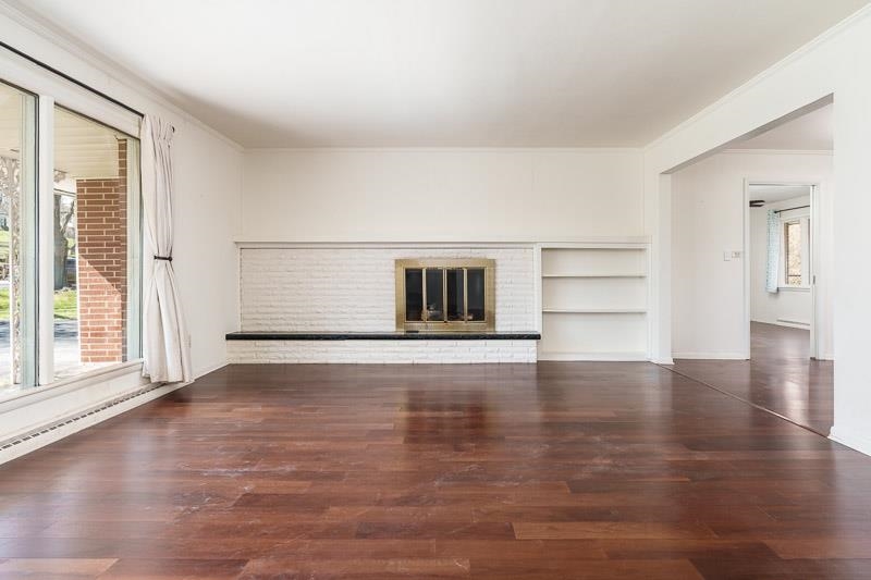 2309 Harris Road Rockford, IL 61107 - Photo 13 of 42 a view of an empty room with a window and wooden floor