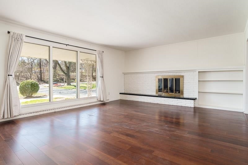 2309 Harris Road Rockford, IL 61107 - Photo 14 of 42 a view of empty room with wooden floor and floor to ceiling window