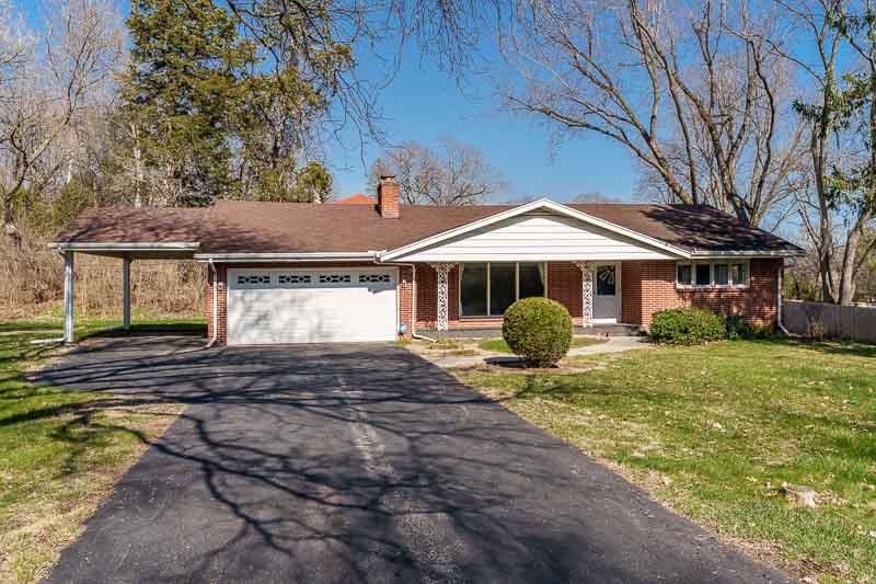 2309 Harris Road Rockford, IL 61107 - Photo 2 of 42 a front view of a house with garden