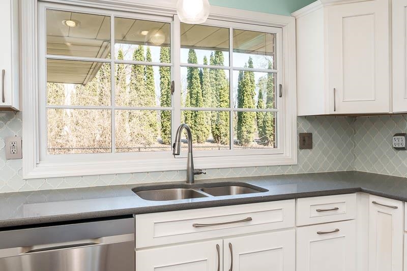 2309 Harris Road Rockford, IL 61107 - Photo 21 of 42 a kitchen with granite countertop a sink and white cabinets