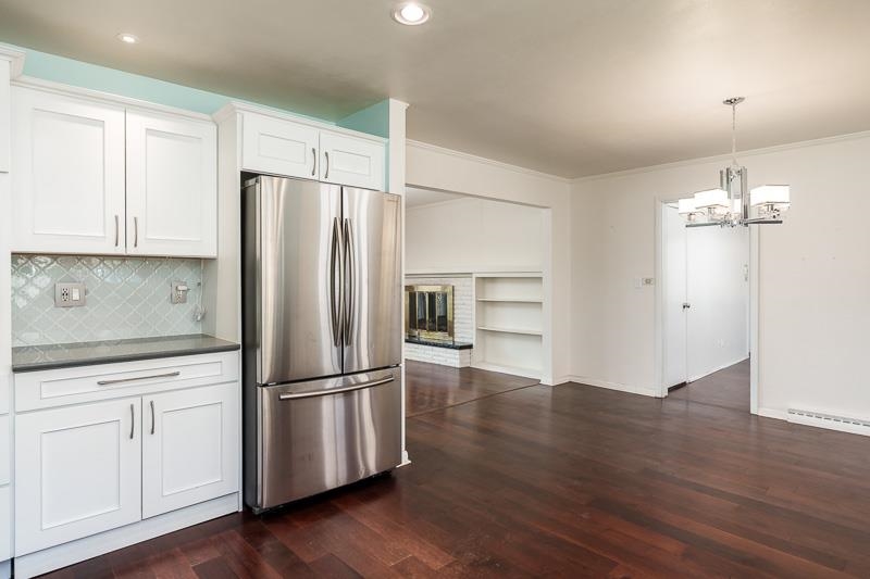 2309 Harris Road Rockford, IL 61107 - Photo 22 of 42 a kitchen with wooden floors appliances and cabinets