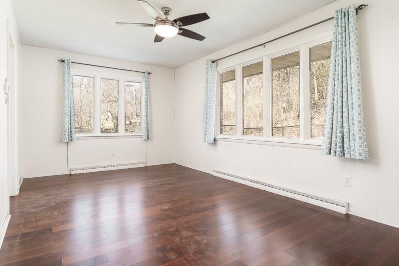 2309 Harris Road Rockford, IL 61107 - Photo 26 of 42 a view of an empty room with wooden floor and windows
