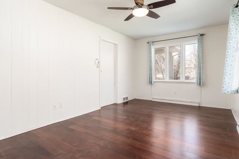 2309 Harris Road Rockford, IL 61107 - Photo 27 of 42 an empty room with wooden floor fan and windows