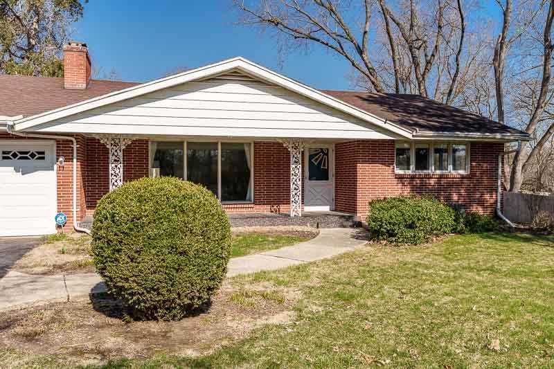 2309 Harris Road Rockford, IL 61107 - Photo 3 of 42 a view of a white house with a large window and potted plants