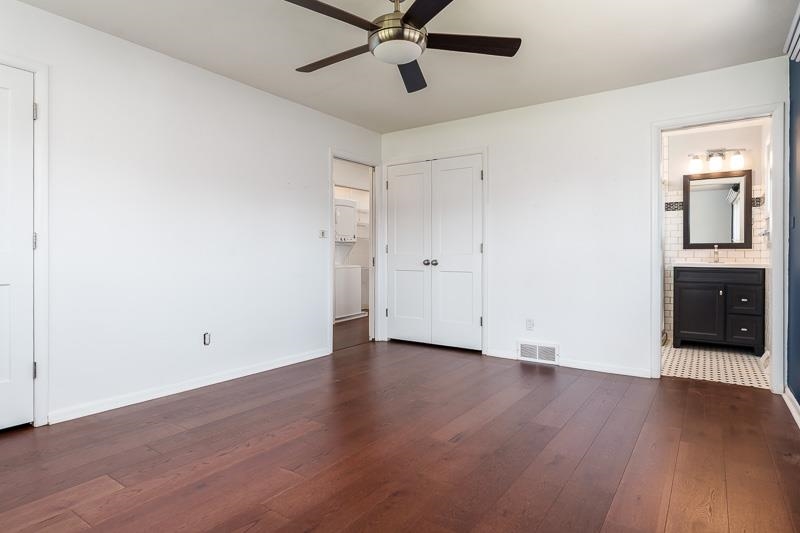 2309 Harris Road Rockford, IL 61107 - Photo 33 of 42 a view of a room with wooden floor and a ceiling fan