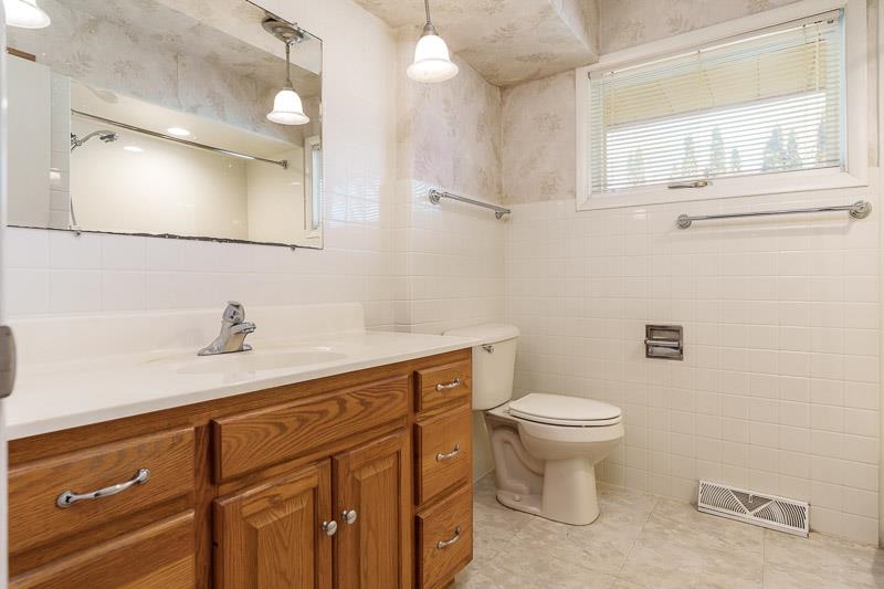 2309 Harris Road Rockford, IL 61107 - Photo 38 of 42 a bathroom with a sink a toilet and mirror