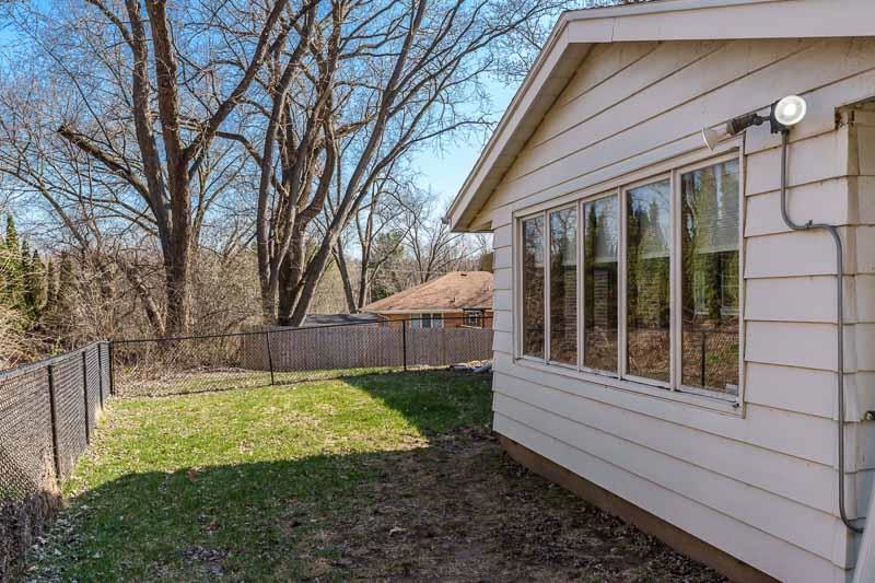 2309 Harris Road Rockford, IL 61107 - Photo 8 of 42 a view of house with backyard outdoor seating and wooden fence