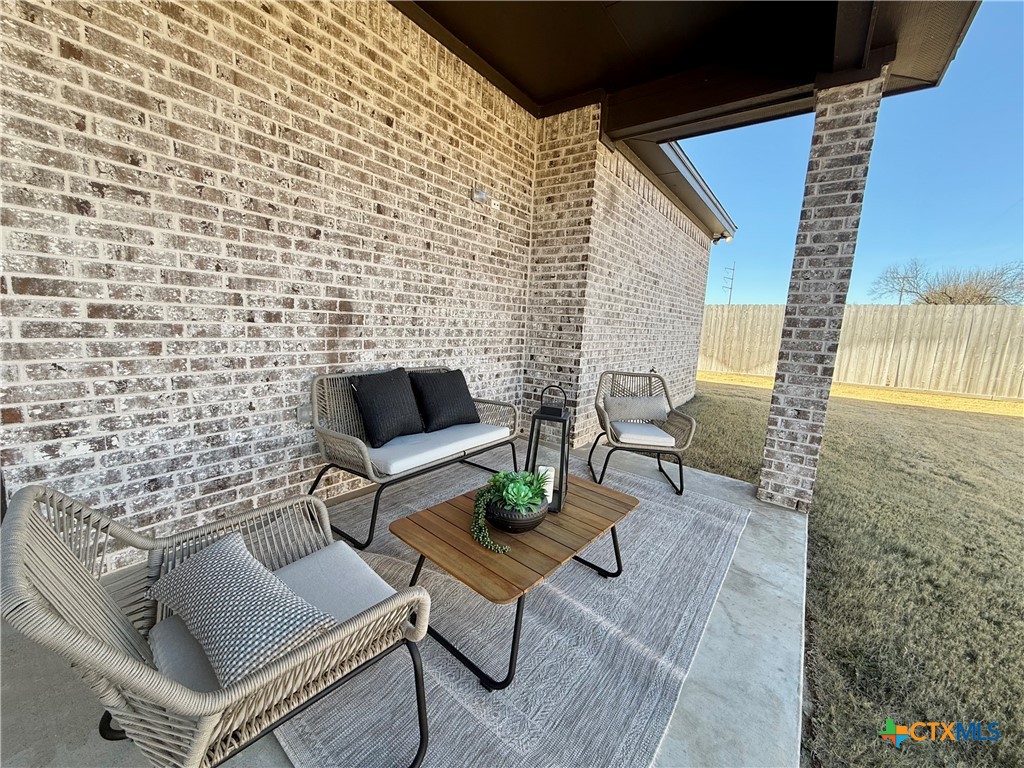 203 Lasso Loop Lorena, TX 76655 - Photo 34 of 37 a outdoor living space with furniture and a fireplace