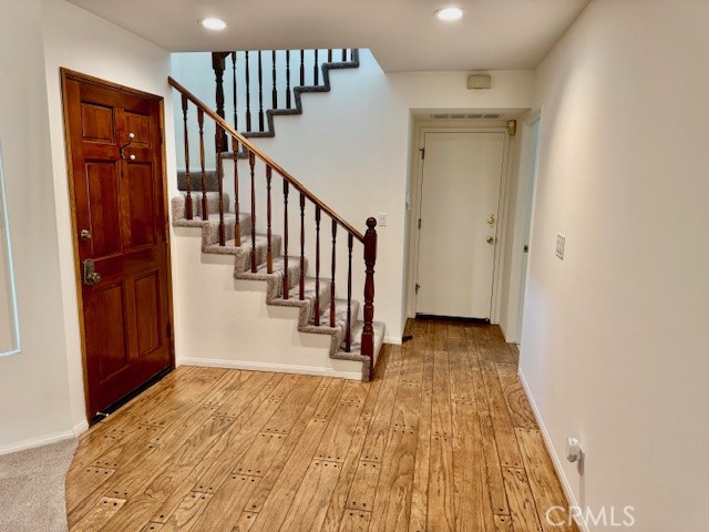 18336 Algiers Street Porter Ranch, CA 91326 - Photo 4 of 18 a view of a hallway with wooden floor and staircase