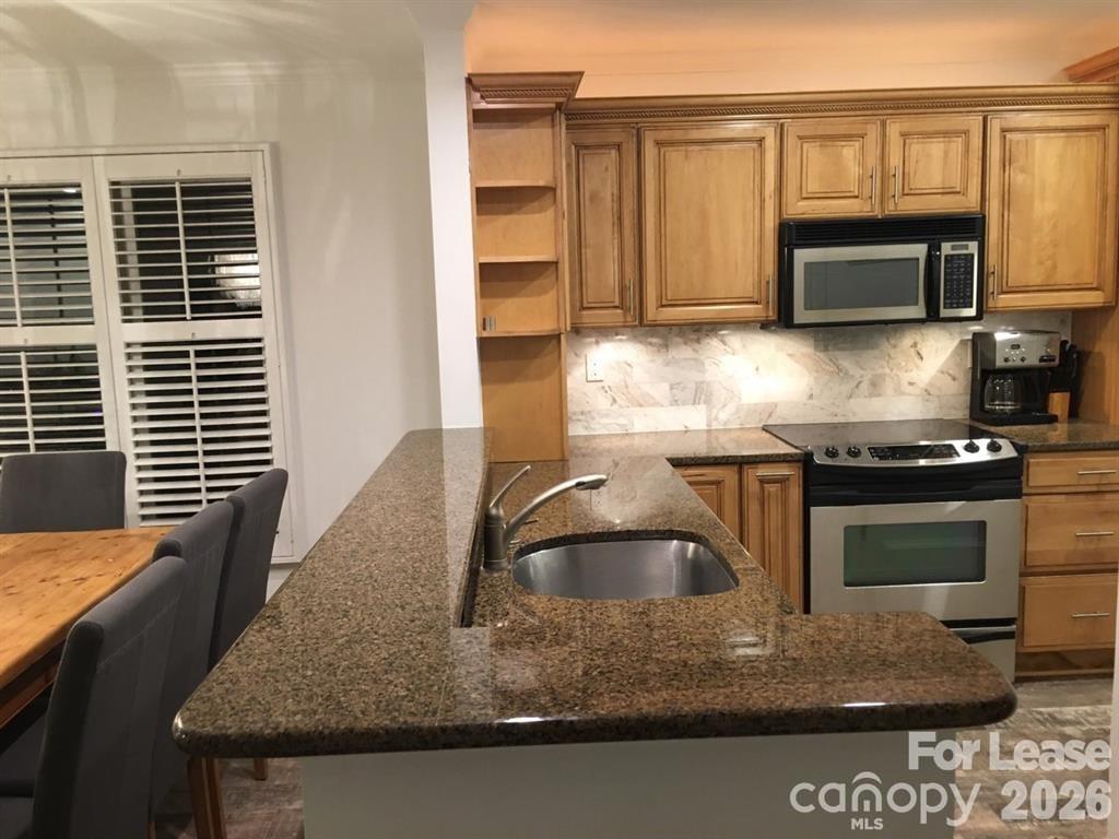 646 Portside Drive Davidson, NC 28036 - Photo 12 of 48 a kitchen with kitchen island a sink stove and microwave