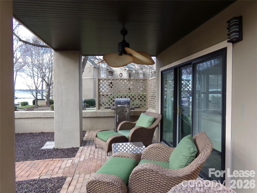 646 Portside Drive Davidson, NC 28036 - Photo 23 of 48 a living room with furniture and a floor to ceiling window