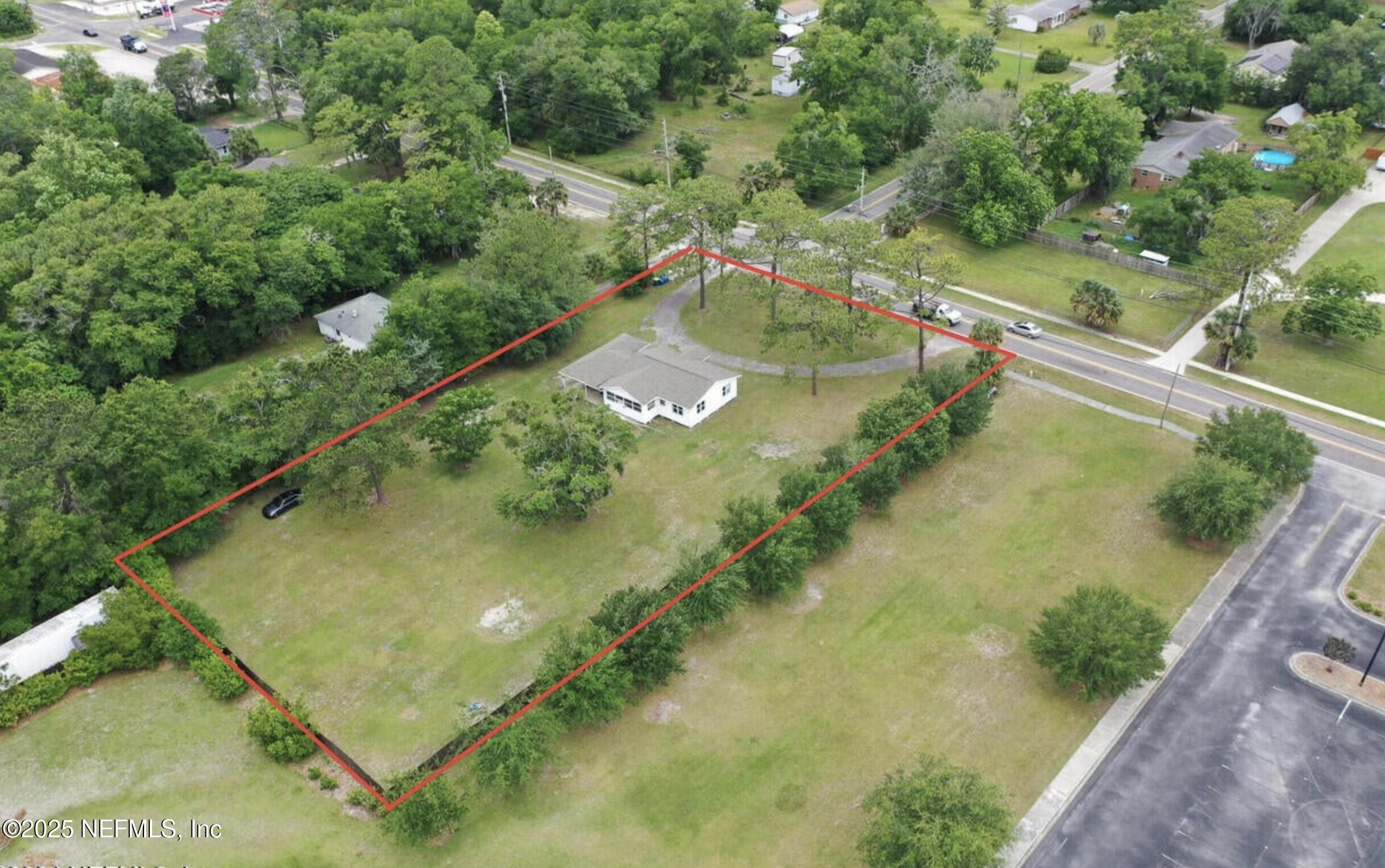 2604 New Berlin Road Jacksonville, FL 32226 - Photo 4 of 6 a view of a swimming pool with a yard and plants