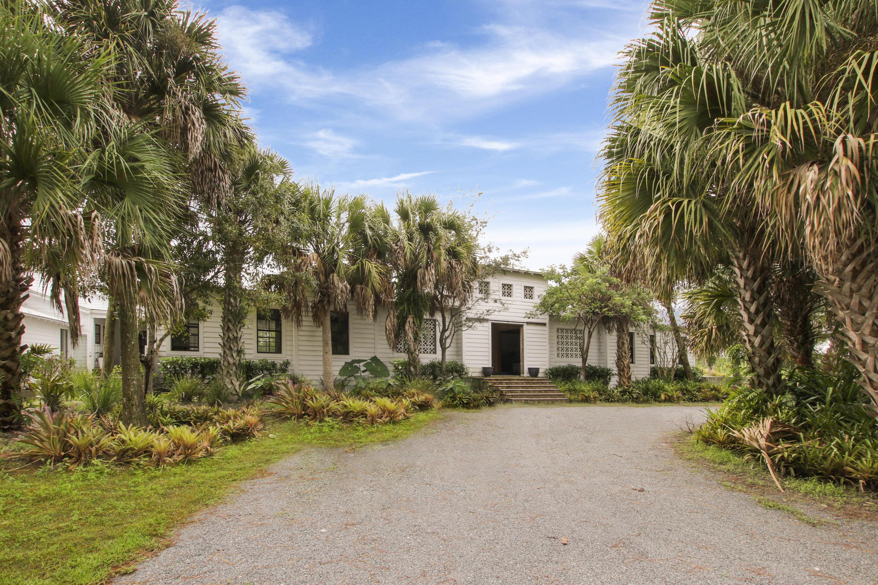 18600 Southeast Mack Dairy Road Jupiter, FL 33478 - Photo 1 of 36 a front view of a house with a yard