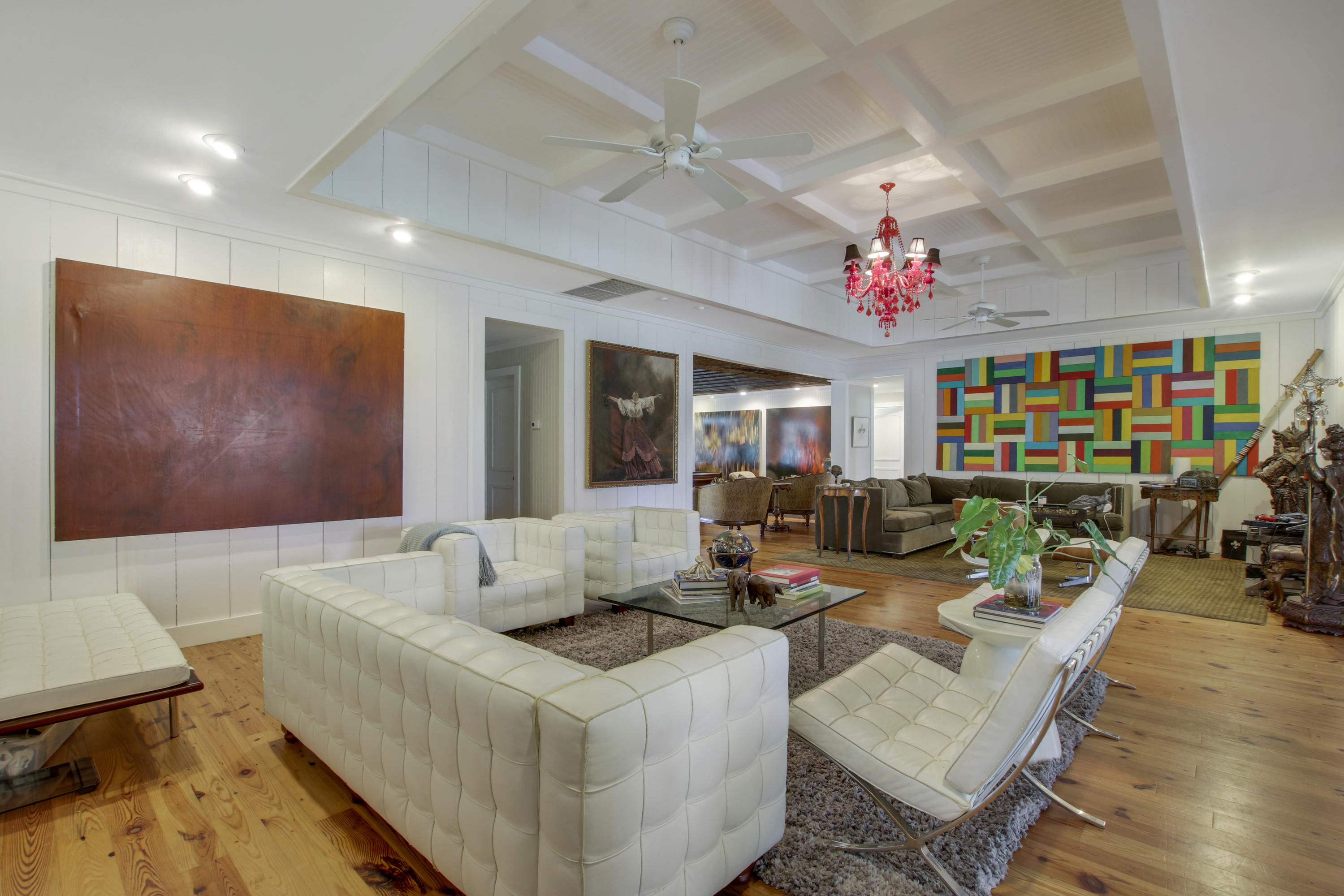 18600 Southeast Mack Dairy Road Jupiter, FL 33478 - Photo 15 of 36 a living room with furniture and a chandelier