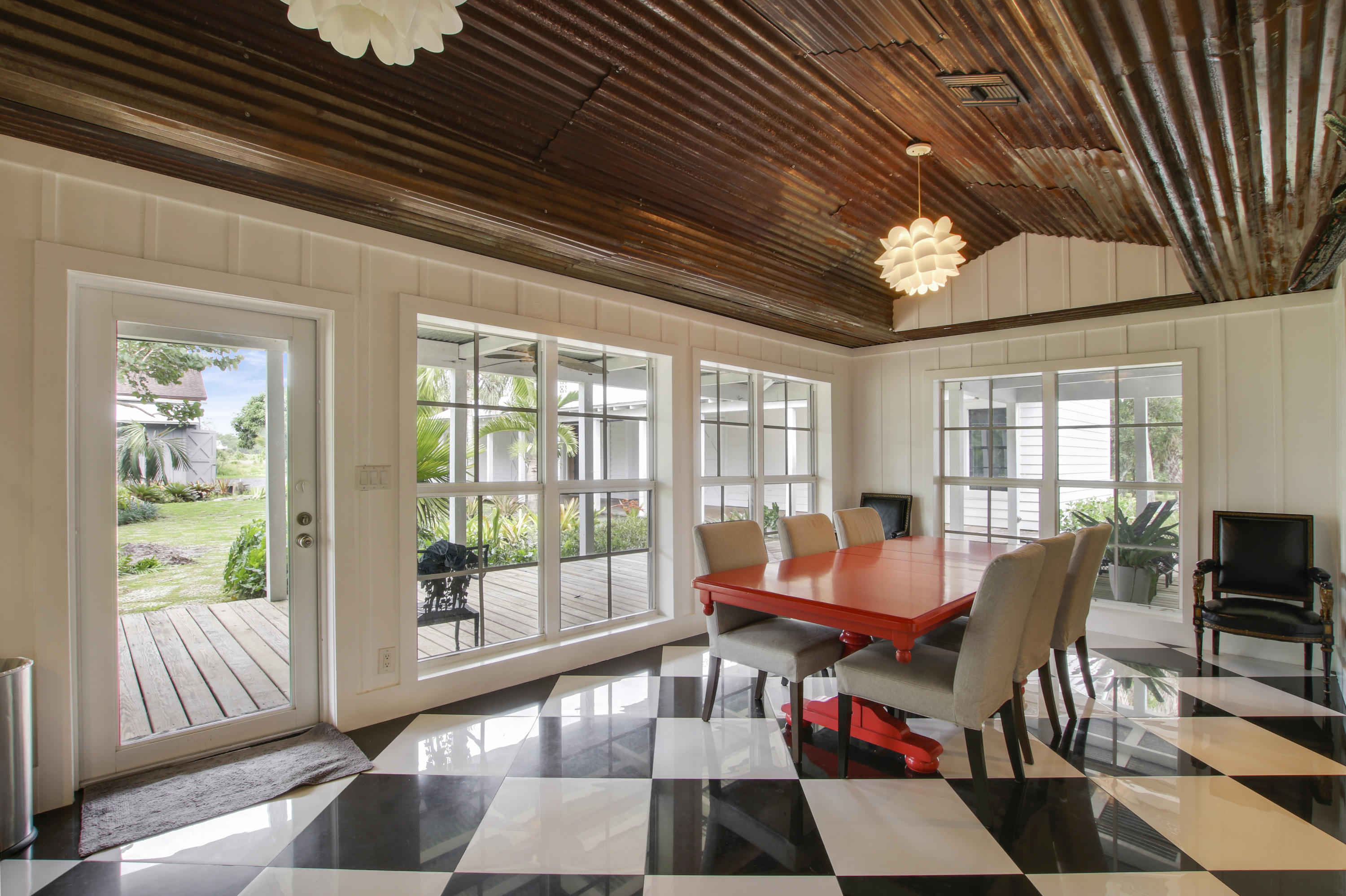 18600 Southeast Mack Dairy Road Jupiter, FL 33478 - Photo 16 of 36 a dining room with furniture a chandelier and wooden floor