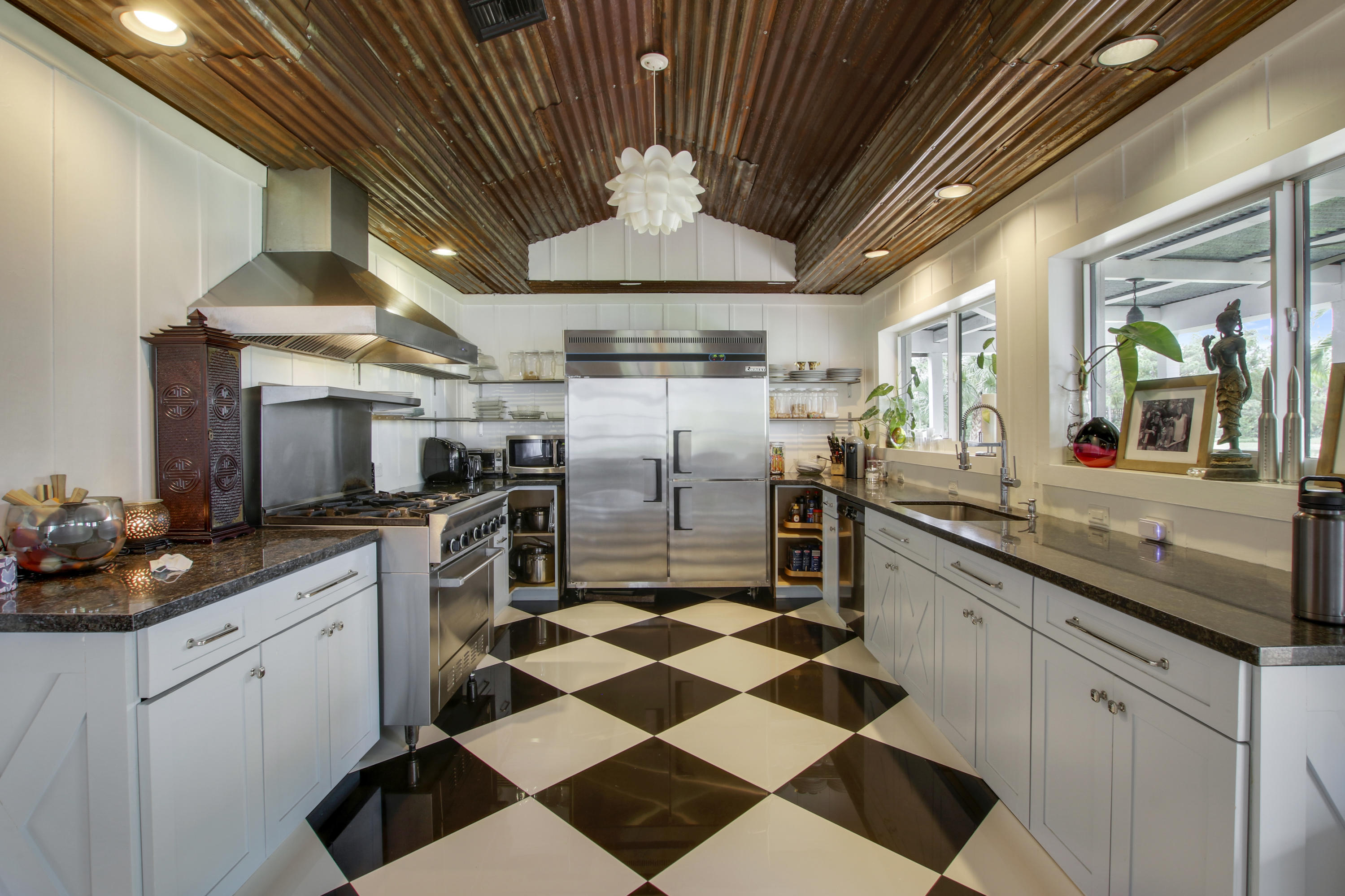 18600 Southeast Mack Dairy Road Jupiter, FL 33478 - Photo 17 of 36 a kitchen with a sink stainless steel appliances and cabinets