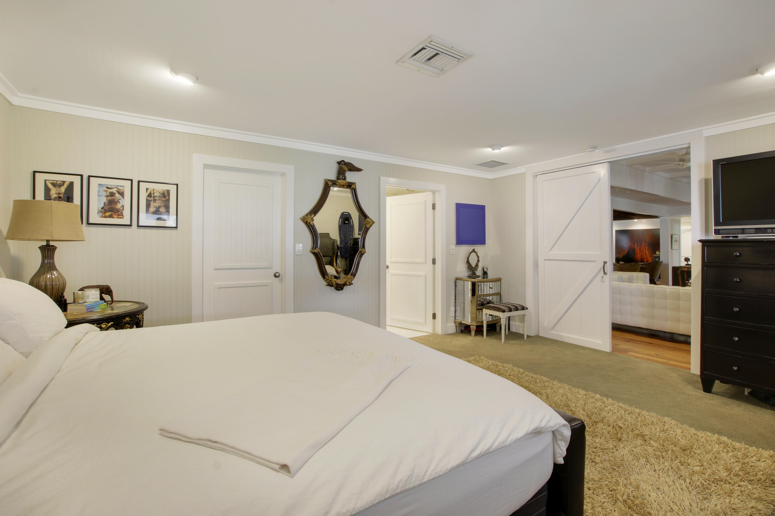 18600 Southeast Mack Dairy Road Jupiter, FL 33478 - Photo 20 of 36 a bedroom with a bed and a tv