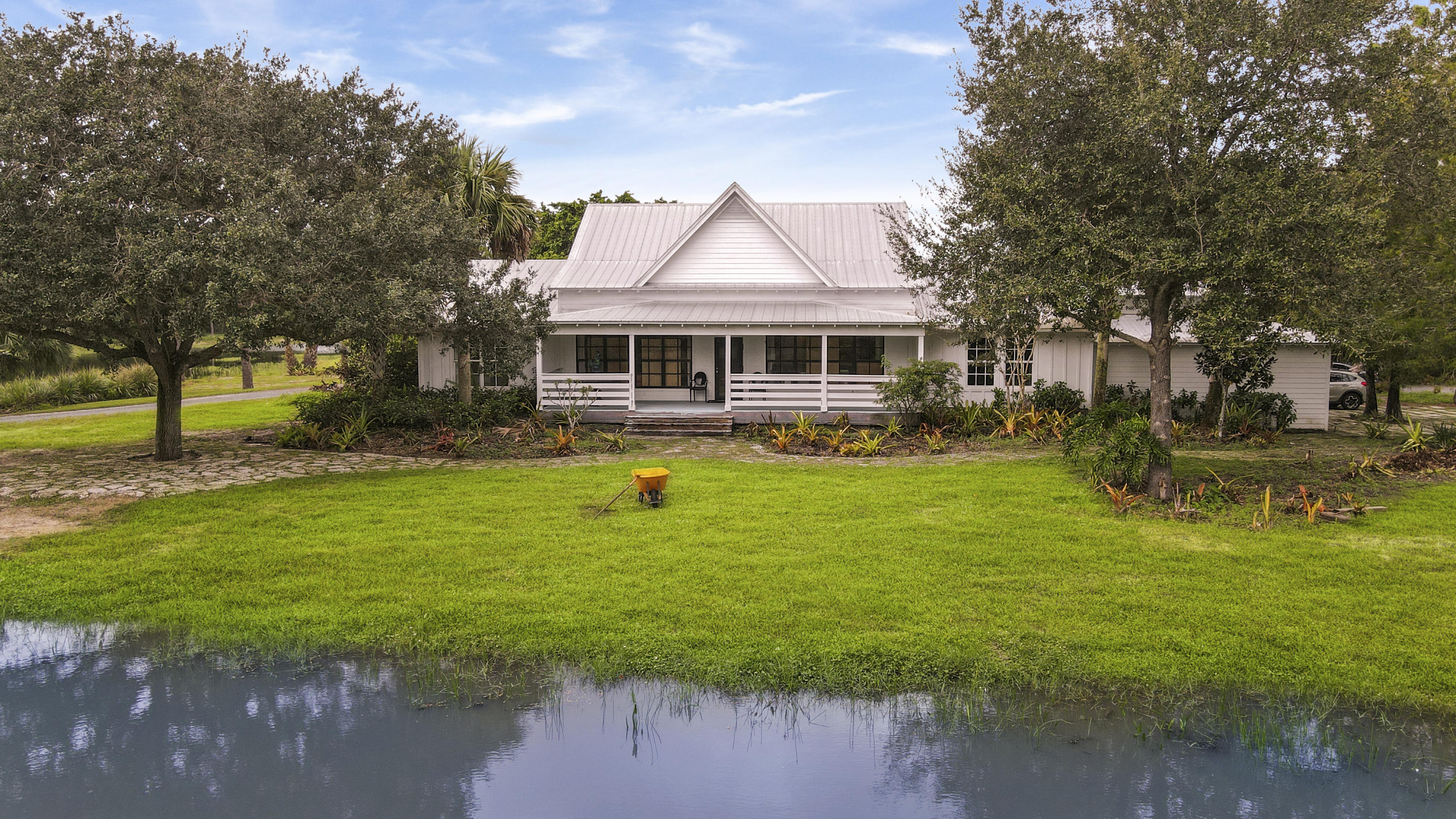 18600 Southeast Mack Dairy Road Jupiter, FL 33478 - Photo 2 of 36 a front view of house with yard and green space