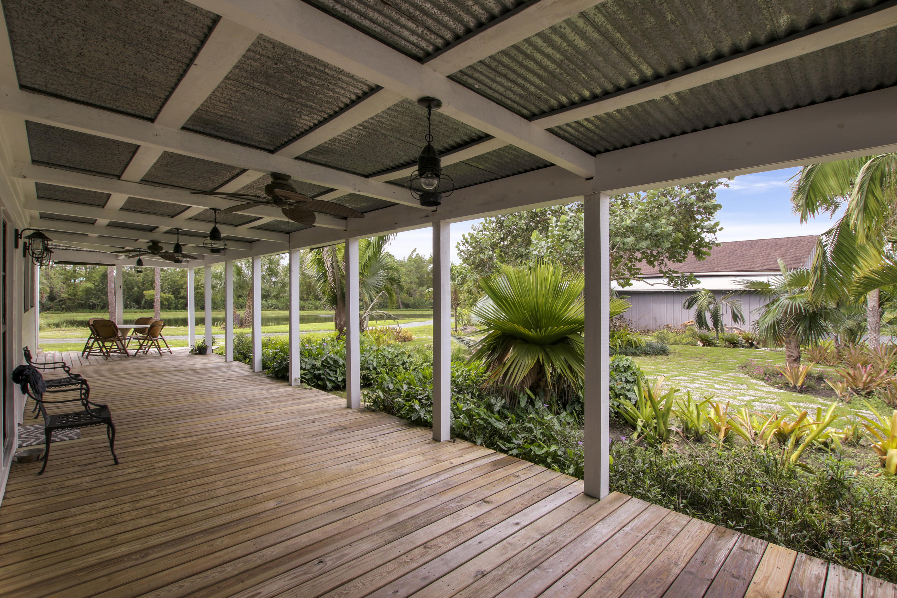 18600 Southeast Mack Dairy Road Jupiter, FL 33478 - Photo 28 of 36 a house with wooden floors in front of it