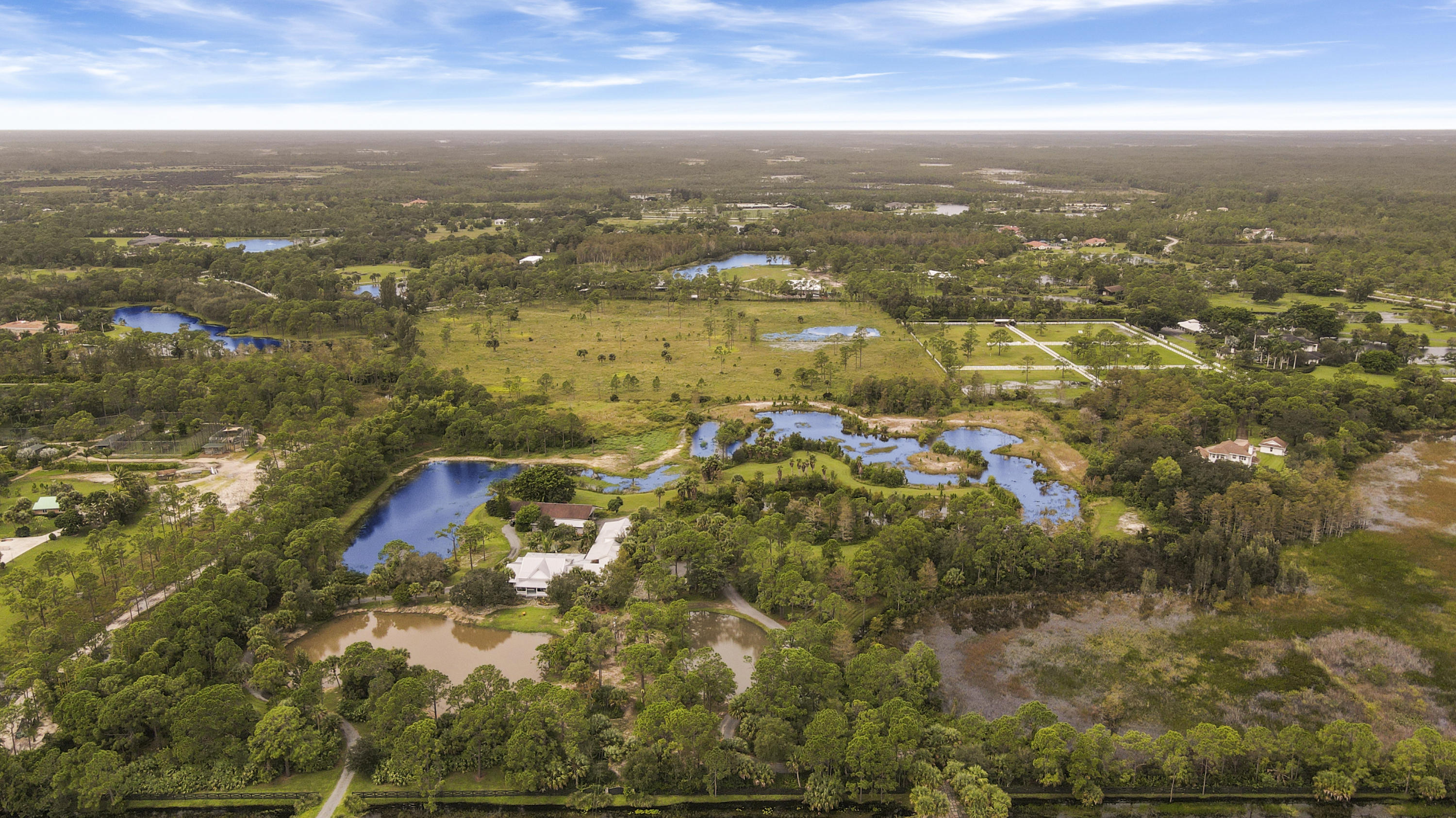 18600 Southeast Mack Dairy Road Jupiter, FL 33478 - Photo 30 of 36 an aerial view of residential building with parking space
