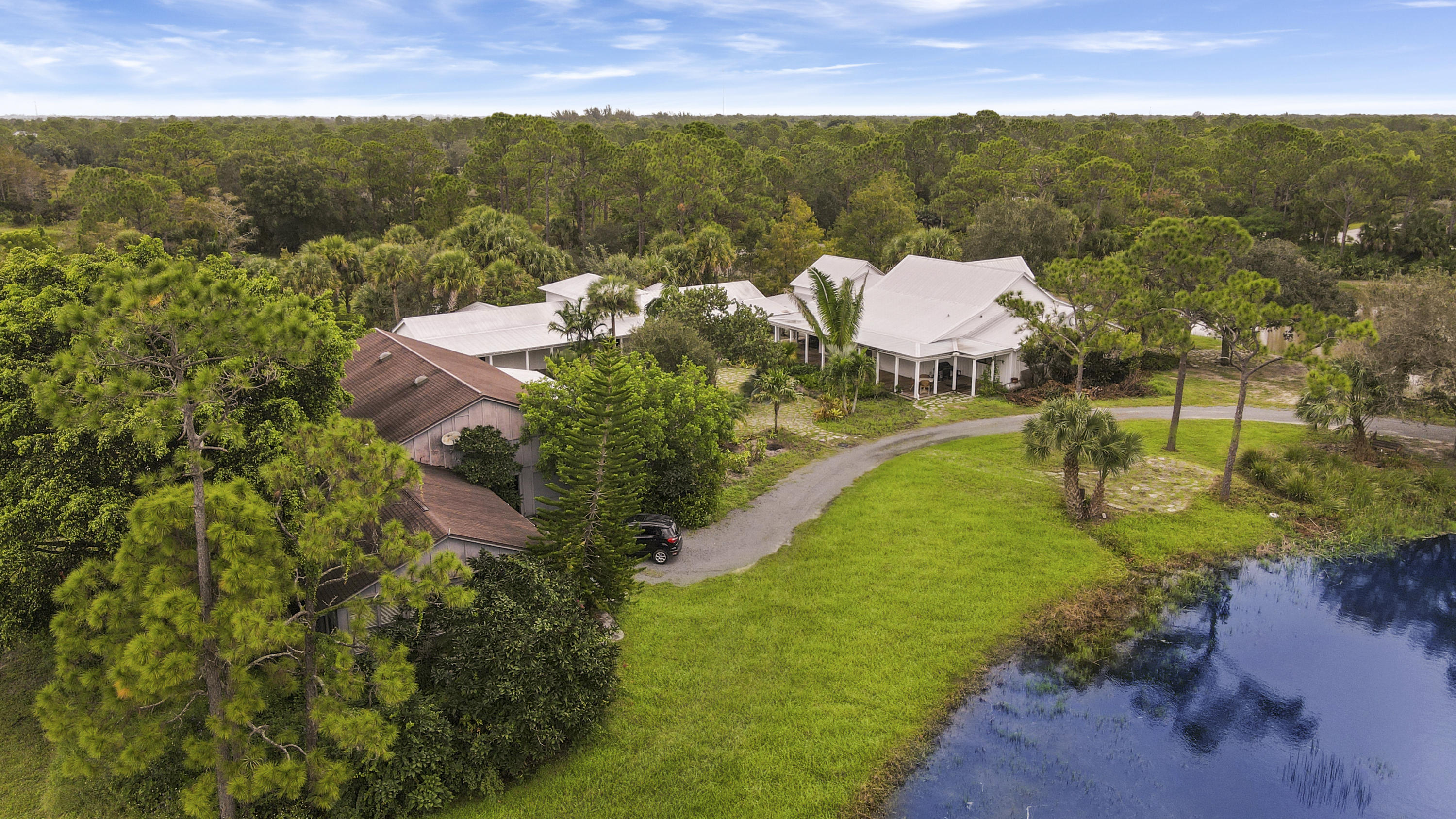 18600 Southeast Mack Dairy Road Jupiter, FL 33478 - Photo 3 of 36 an aerial view of residential houses with outdoor space and trees
