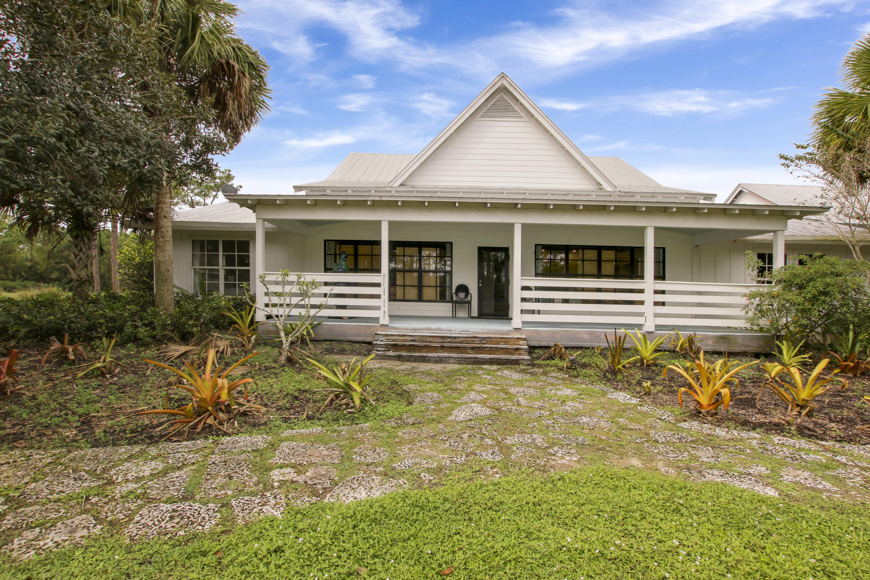 18600 Southeast Mack Dairy Road Jupiter, FL 33478 - Photo 32 of 36 front view of a house with a small yard