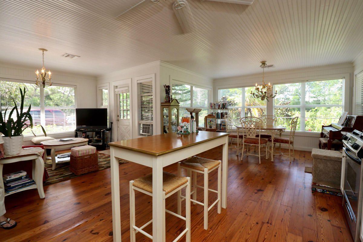 18600 Southeast Mack Dairy Road Jupiter, FL 33478 - Photo 35 of 36 a view of a dining room with furniture window and wooden floor