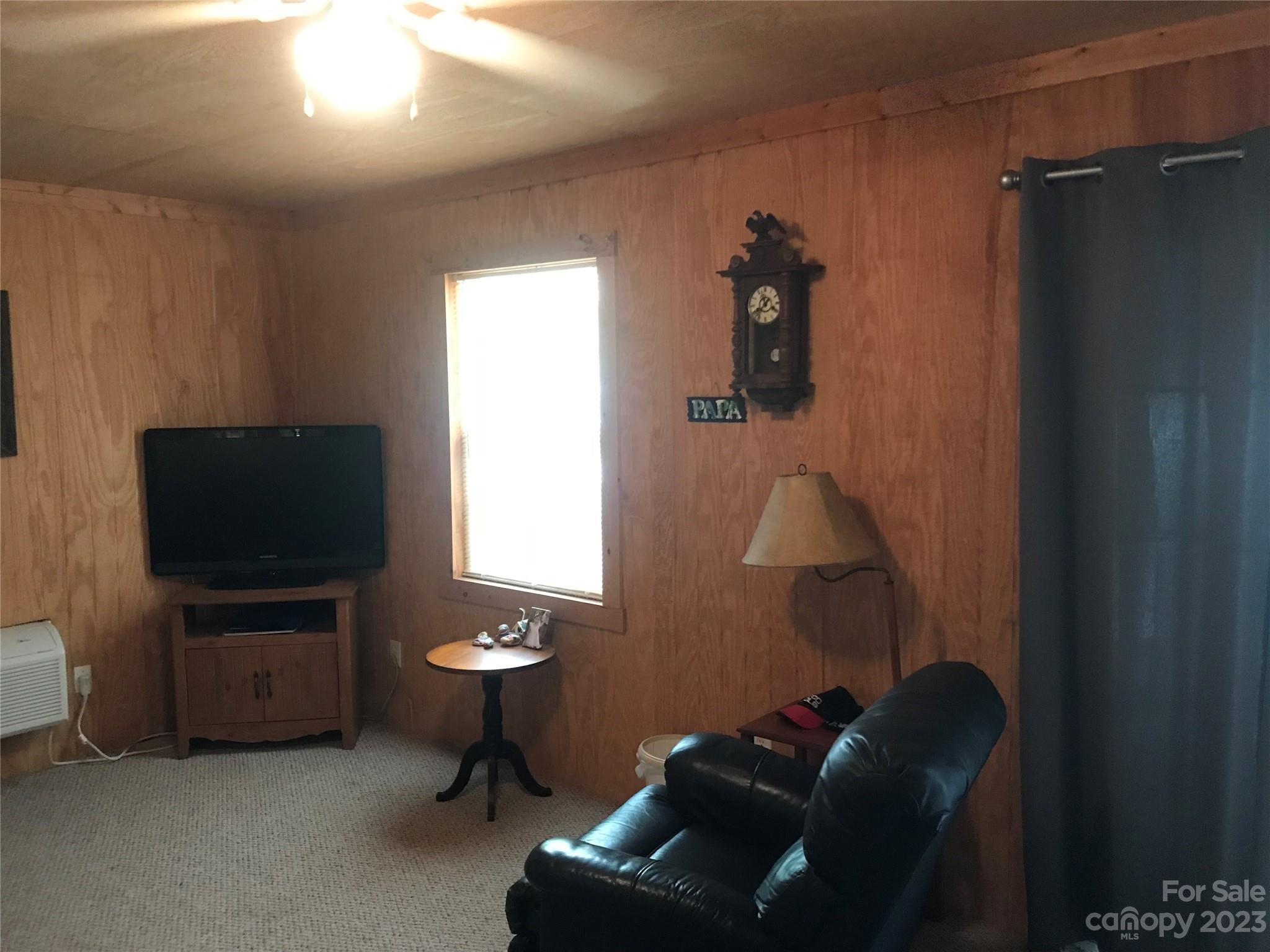 154 Roberts Ridge Road Mount Gilead, NC 27306 - Photo 11 of 35 a living room with furniture and a flat screen tv